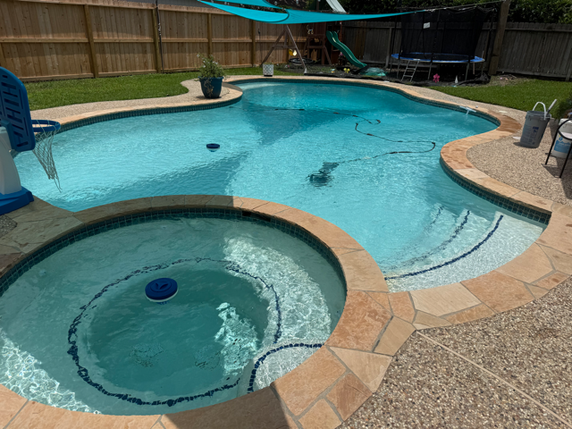 In-ground pool and spa with clear, properly balanced water after testing and chemical balancing