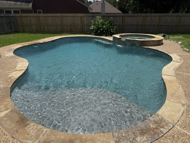 The same in-ground pool after green pool recovery, with clear blue water and a visible pool floor
