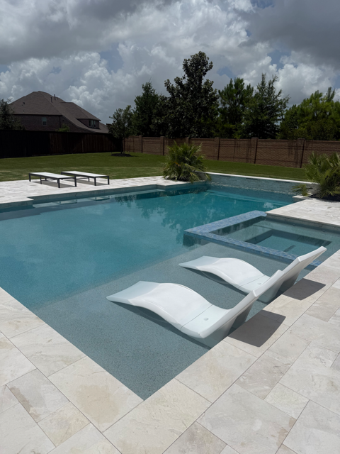 Modern in-ground pool and spa on a scheduled pool maintenance plan